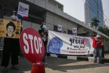 Activists from civil society coalition against coal power plant unfurled banners and posters while holding a rejection of the Java 9 and 10 mega coal power plant project in front of the South Korean Embassy, Jakarta, on 25 June 2020.