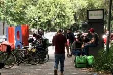 Foot and bike food-app workers waiting an order out of a mall