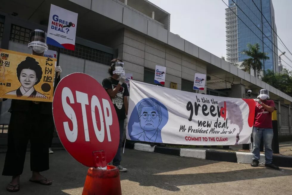 Activists from civil society coalition against coal power plant unfurled banners and posters while holding a rejection of the Java 9 and 10 mega coal power plant project in front of the South Korean Embassy, Jakarta, on 25 June 2020.